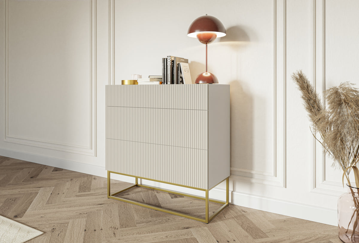 Commode Veldio avec façade rainurée et trois tiroirs 90 cm Gris beige avec pieds dorés