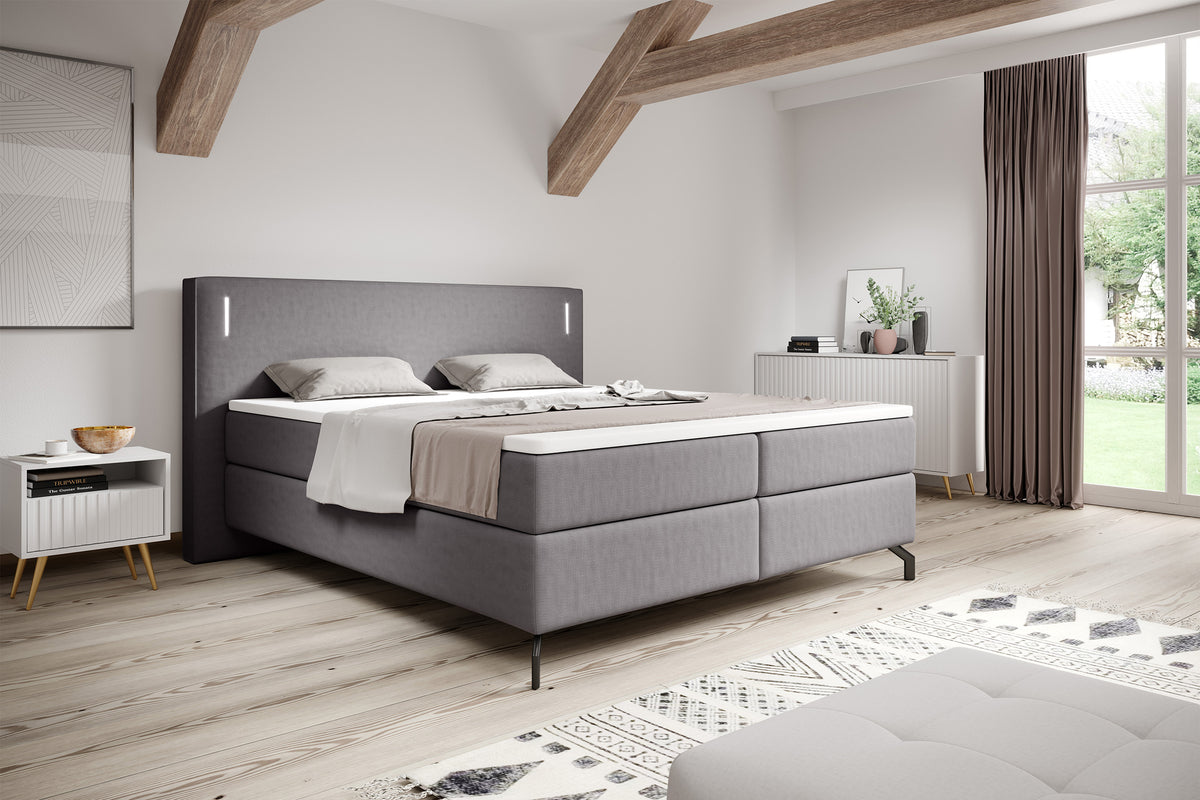 Lit continental Lanko 180x200 cm en velours gris avec topper et éclairage