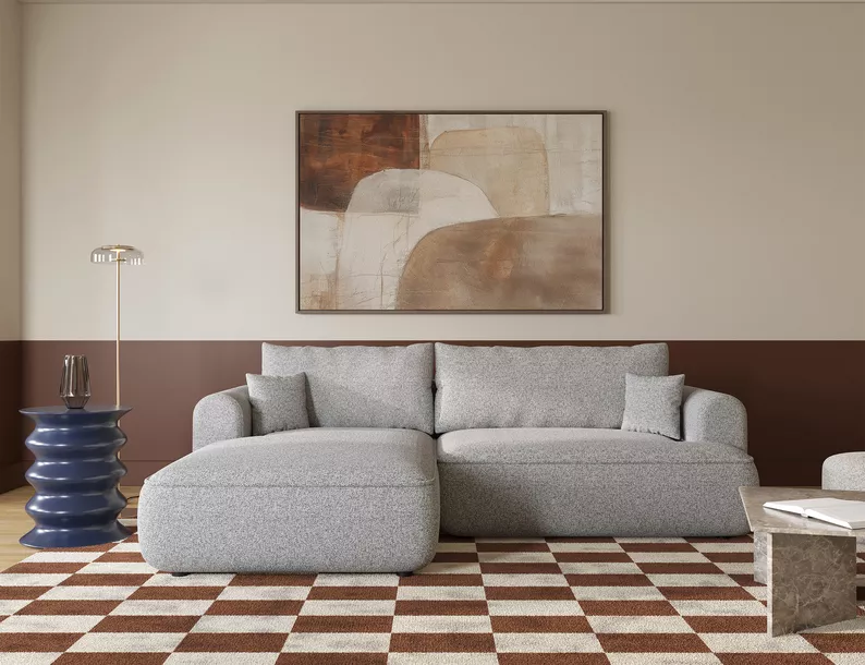 Jasnoszary narożnik Ovo lewostronny z funkcją spania i pojemnikiem na pościel.