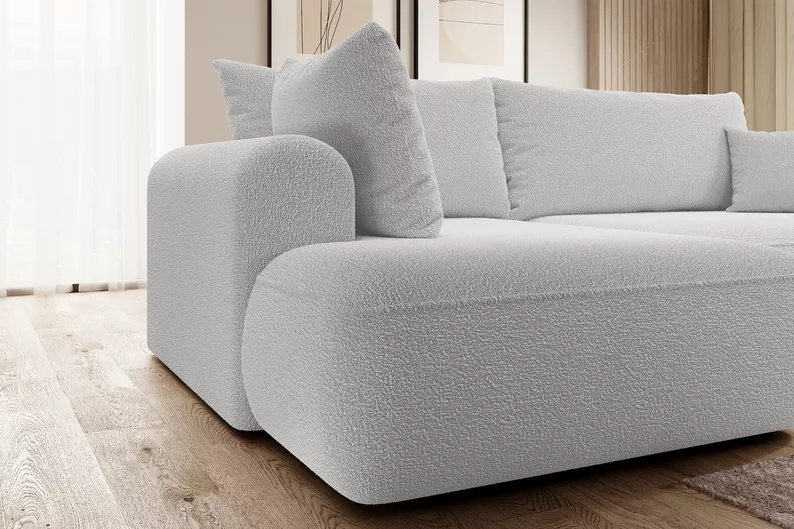 Szary narożnik Ovo L-kształtny z funkcją spania i pojemnikiem na pościel, idealny do salonu.