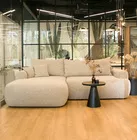 Jasnoszary narożnik Ovo lewostronny z funkcją spania i pojemnikiem na pościel.