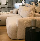 Jasnoszary narożnik Ovo lewostronny z funkcją spania i pojemnikiem na pościel.